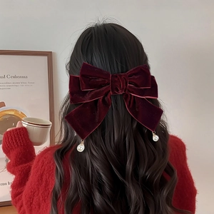 Detailed back view of a burgundy velvet bow hair clip featuring elegant pearl pendants
