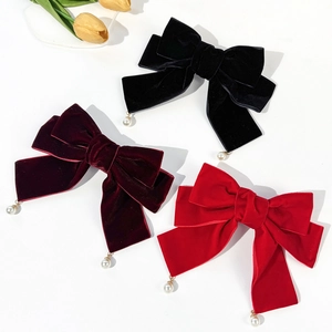 Elegant velvet bow hair clips in black and red with pearl pendants on white background