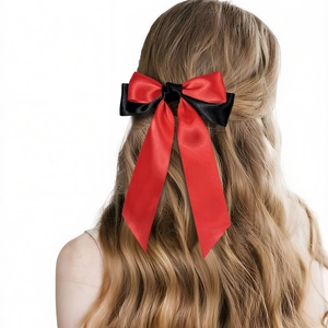 Detail of red and black satin bow hair clip with long ribbons on a model back view