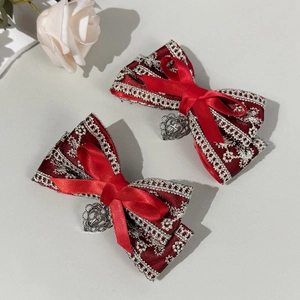 Close-up of wine red Lolita bow hair clips with silver lace and heart cross pendants
