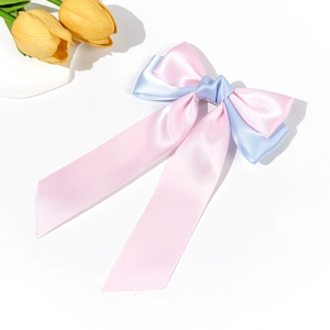Detail view of pink and blue satin ribbon bow with long streamers and smooth texture