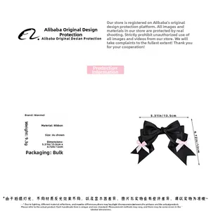 Detail view of black Lolita style bow hair clip with pink ribbon and size measurements