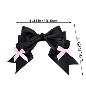 Detailed view of black satin bow hair clip with pink silk accents and 13.5cm dimensions