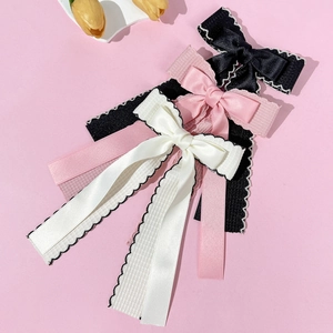 Elegant double-layered bow hair clips in black, pink, and white with long ribbon streamers