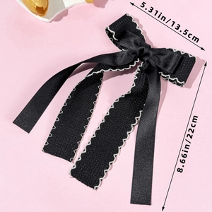 Detail showing dimensions of black satin double-layered bow hairclip with white wavy edges