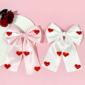 Elegant satin bow hair clips in pink and white with red heart patches for women