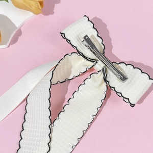 Elegant white fabric double-layered bow hair clip with black stitching and silk ribbons