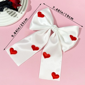 Elegant white satin hair bow with red heart embroidery and dimensions 25x19cm