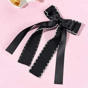 Elegant double-layered black bow hair clip with white wavy edges and long satin ribbons