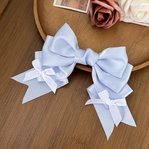 Elegant light blue satin bow hair clip with white accents in a French vintage style