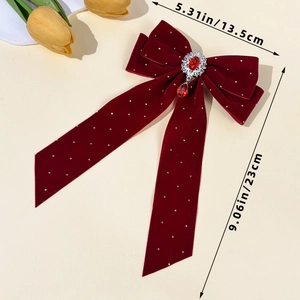 Detail view of red velvet bow hair clip with ruby pendant and size measurements