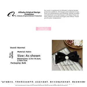 Detail einer schwarzen Samt-Haarschleife mit elegantem Perlen- und Strass-Anhänger