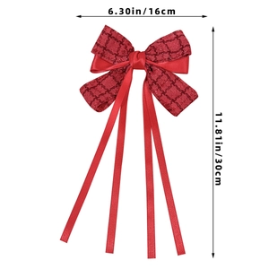 Detail view of red plaid bow hair clip with ribbons measuring 16cm wide and 30cm long