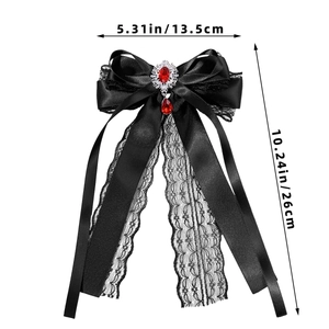 Detailed view of gothic black lace bow hairpin with red ruby pendant and rhinestones