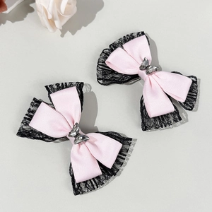 Detail of pink satin bows with black lace trim and silver crystal butterfly center