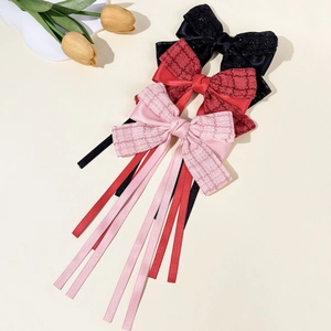 Set of three elegant bow hair clips in black, wine red, and pink with long satin ribbons