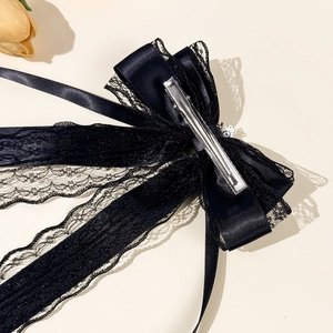 Elegant black lace bow hair clip with long ribbons and metal duckbill clip back view