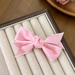 Elegant pink velvet bow hair clip for girls with a vintage minimalist aesthetic design
