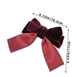 Detailed view of the red velvet and satin bow hair clip measuring 4.13 by 4.33 inches