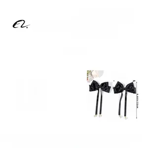 Detailed view of black ribbon hair clips with white pearls including dimensions 13.5x22cm