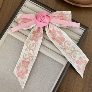 Pink Chinese embroidery flower bow hair clip in a vintage style jewelry display box