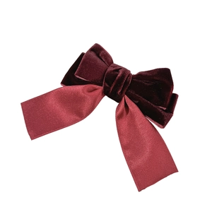 Elegant burgundy velvet bow hair clip with satin ribbons for a vintage French hairstyle