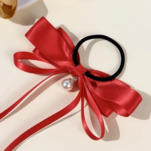 Elegant red satin bow hair tie with a pearl pendant and flowing ribbons for women