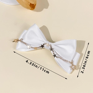 Detailed view of white satin bow hair clip with gold star chain and size dimensions