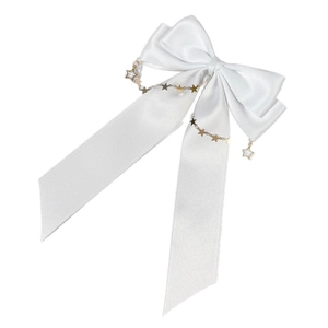 White satin bow hair clip with hanging gold star chains and long flowing ribbons
