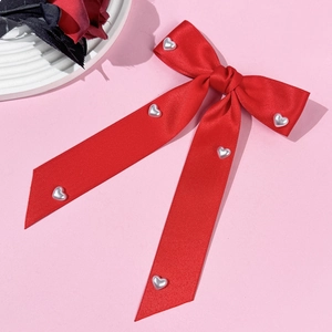 Elegant red satin bow hair clip with pearl heart charms and long flowing ribbons