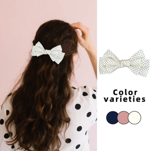Sweet girl's polka dot bow hair clip available in navy, pink, and white colors