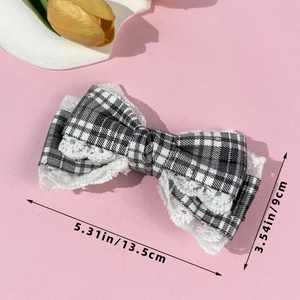 Detail of 13.5cm plaid bow hair clip with white lace trim and sparkling sequins
