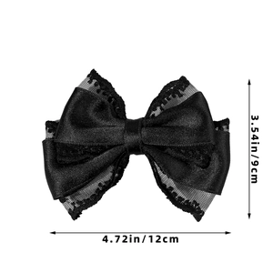 Detail view of black lace and satin bow hair clip showing 12cm width and 9cm height dimensions