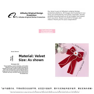 Detail of red velvet bow hair clip with pearl chains and heart ornament for women