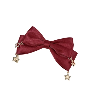 Elegant wine red satin bow hair clip with gold star pendants on a clean white background