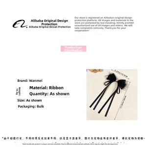 Detail of elegant black mesh bow hair clip with long ribbons and珍珠 details