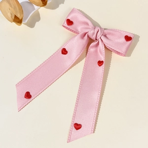 Elegant pink satin bow hair clip with red 3D hearts and long ribbons for women