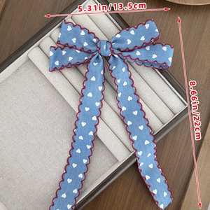 Blue denim style hair clip with white heart prints and red wavy trim dimensions 13.5x22cm