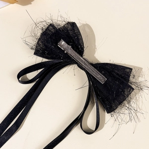 Elegant black mesh bow hair clip with flowing ribbons and shiny silver fibers
