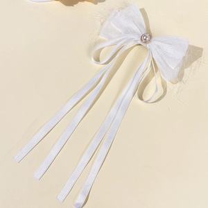 Elegant white ribbon bow hair clip with center pearl and long tassels for women