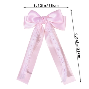 Pink satin bow hair clip with white lace trim details, showing dimensions 13cm by 23cm