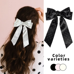 Fiocco per capelli a pois in stile francese con lunghi nastri in nero e bianco