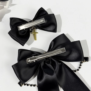 Black satin bow hair clips with gold cross pendants and beaded chains on metal clips