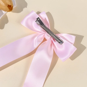 Pink satin bow hair clip with French luxury design and durable silver metal clip