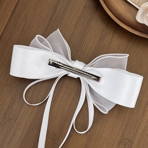 Elegant white mesh bow hair clip with satin ribbons shown from the back view