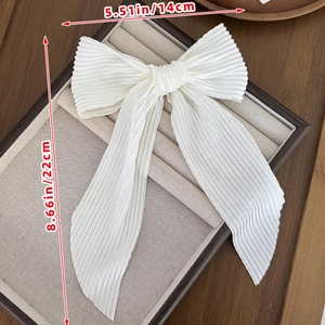 Detailed view of white pleated chiffon bow hair clip showing 22cm x 14cm dimensions