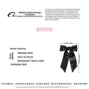 Detail showing oversized black satin bow hair clip with dimensions 16x24cm and 28.4g weight