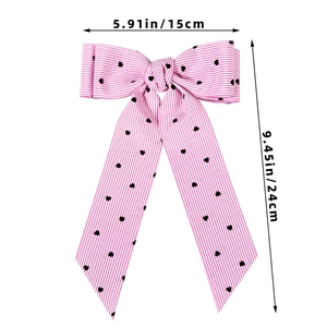 Pink striped hair bow with heart pattern, size 15cm wide by 24cm long for girls