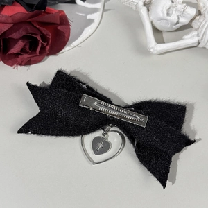 Gothic black velvet bow hair clip with silver heart cross pendant on aesthetic dark background