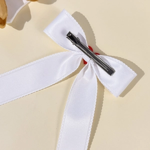 Elegant white satin ribbon bow hair clip with silver metal alligator grip on back view
